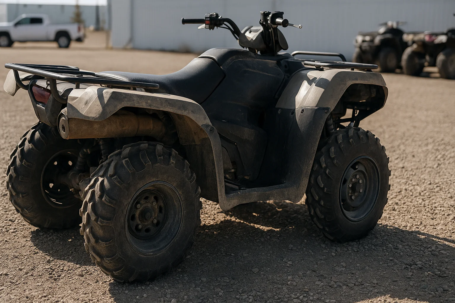 Close walk-around view of a used ATV tire plastics and underbody on a gravel lot during inspection